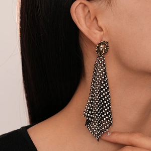 Retro lion head drop earrings with rhinestone mesh tassels shown on a model