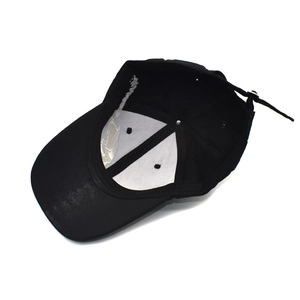 Internal view of black embroidered skull baseball cap with adjustable strap and lining