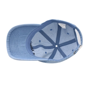 Detail view of denim baseball cap interior stitching and adjustable metal buckle closure