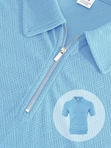 Detail shot of light blue polo fabric texture and zipper neckline with size label