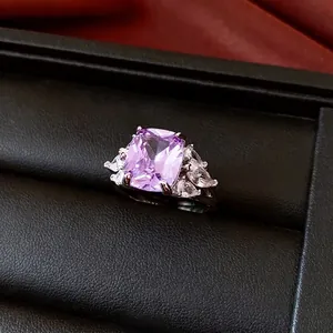 French palace style ring with rectangular purple zircon and silver band in a jewelry box