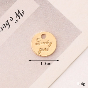 Detailed view of a 1.3cm gold Lucky Girl charm pendant for DIY jewelry making