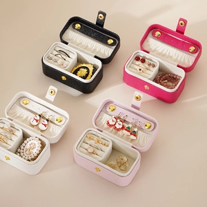 Portable jewelry storage box for travel in various colors with organized compartments