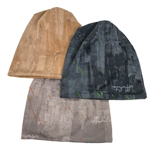 Distressed knit beanies in khaki, black, and grey with abstract graffiti patterns