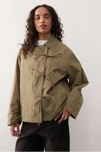 Detail of army green cotton jacket featuring unique front ribbon ties and loose lapels