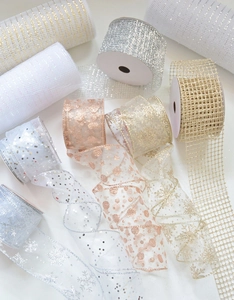 Close-up of sparkling chiffon ribbons with sequins and snowflake prints for Christmas décor