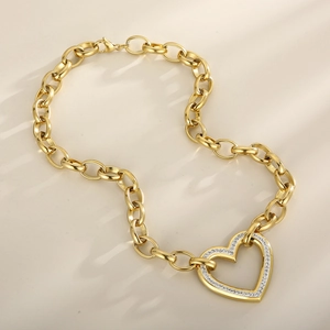 Detail of gold chunky chain necklace featuring a crystal-embellished heart pendant