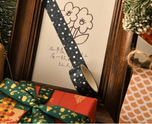 Detail of dark washi tape with silver foil stars wrapped on a vintage frame