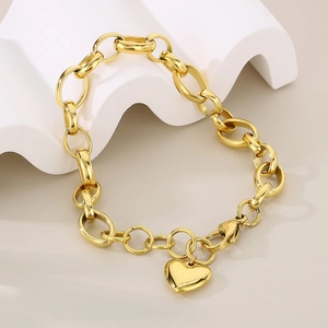 Detail of chunky gold-plated oval link chain bracelet with polished heart pendant