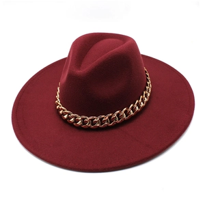 Top view of a wide brim burgundy wool fedora hat with a chunky gold chain decoration