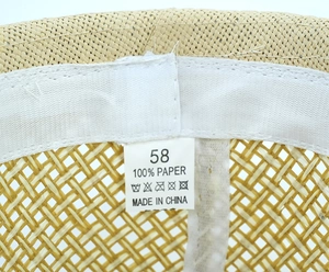 Detail view of woven paper straw hat interior with sweatband and size 58 label