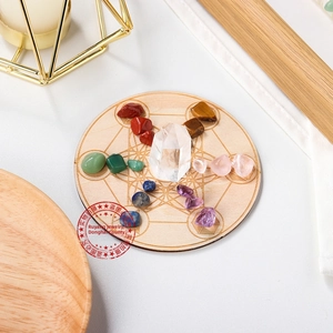 Macro detail of chakra healing stones set on a laser engraved wooden display base