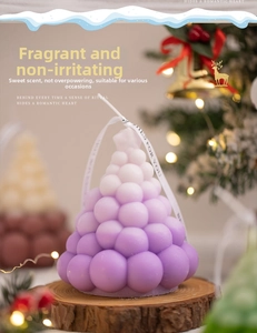 Detailed view of a purple gradient bubble Christmas tree scented candle on a wooden base