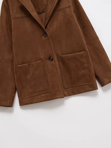 Close-up of brown faux suede blazer featuring large patch pockets and button closure