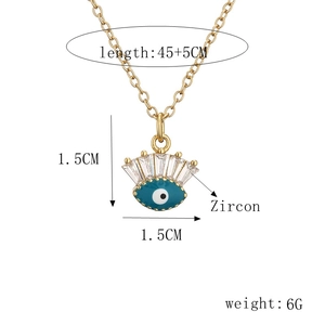 Detail view of gold chain necklace with blue devil eye zircon pendant and measurements