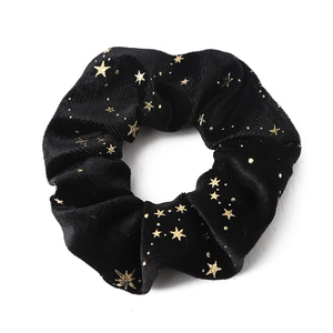 Black velvet scrunchie with gold star pattern for stylish high ponytail hairstyles