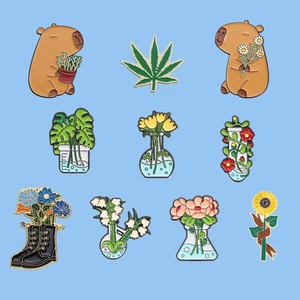 Set of 10 creative enamel pins featuring cute capybaras and floral laboratory flasks