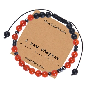 Detail of Morse Code bracelet with red agate beads and handmade A New Chapter card