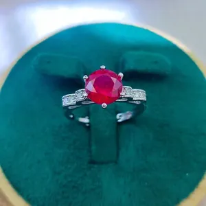 Macro detail of a 2-carat red ruby ring featuring a six-prong setting on white metal