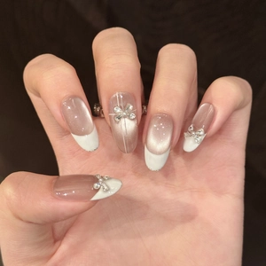 French taupe cat eye press-on nails with 3D rhinestone bows and pearl accents