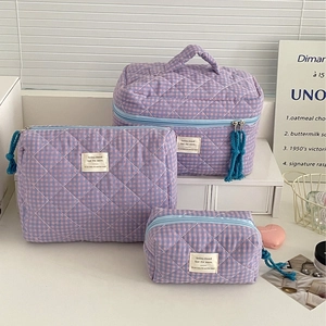 Three-piece checkered makeup bag set with purple and blue quilted fabric and top handle