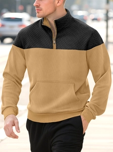 Detail of khaki and black patchwork polo shirt featuring quilted shoulders and ribbed texture