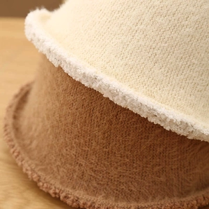 Close-up of warm faux lamb wool texture on beige and khaki bucket hats for women