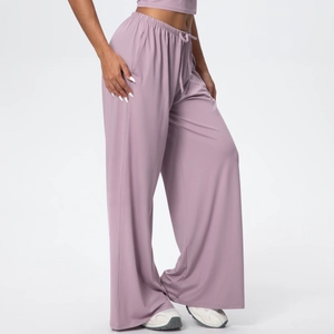 Close-up of high-waist dusty pink wide-leg trousers with drawstring and soft knit texture