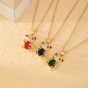 Detail of bear pendant necklaces in red, blue, and green crystals on gold-plated chains