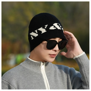 Close-up of black ribbed knit beanie with white NY embroidery and vertical textures