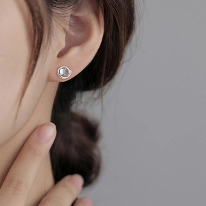 Elegant silver Saturn planet stud earrings featuring light blue glaze stone and zircon accents