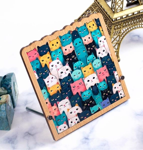 Detailed view of rectangular wooden cat decor with wavy edges and colorful cartoon patterns