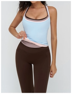 Close-up of layered yoga tank top in pastel colors and high waist leggings with side pockets