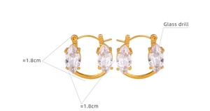 Dettaglio macro di orecchini a cerchio dorati con cristalli di vetro taglio marquise