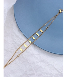 Detail of 18k gold plated double-layer chain bracelet with geometric rhombus accents