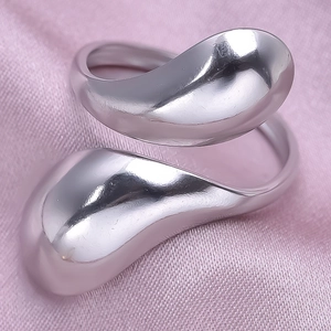 Macro view of polished 304 stainless steel irregular wrap ring on pink silk fabric