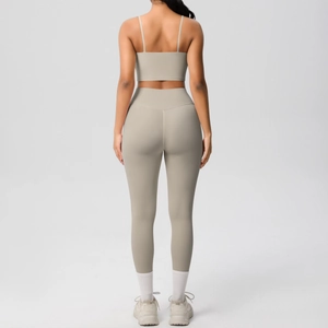 Back view of beige yoga set showing thin strap sports bra and high-waisted leggings