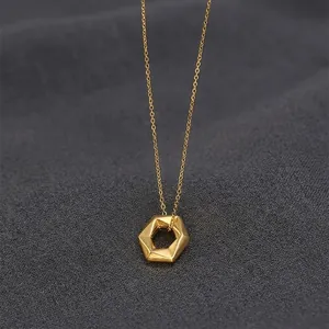Detailed view of a gold geometric hexagonal pendant necklace with a delicate link chain