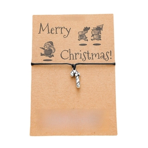 Christmas card bracelet with candy cane pendant and handmade woven rope on kraft paper