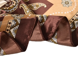 Silk scarf with dark brown paisley pattern and geometric details on white background