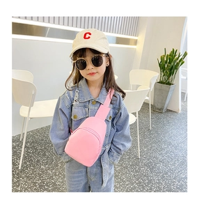Close-up of pink toddler chest bag worn by girl in casual outfit for daily styling