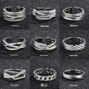 Macro shot of nine S925 sterling silver rings featuring woven and geometric patterns