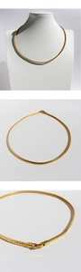 Detailed views of gold flat snake bone choker showing clasp and textured metal surface
