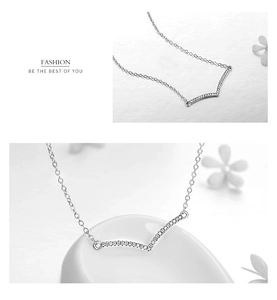 Macro detail of V-shaped pavé diamond pendant on a 925 sterling silver chain necklace