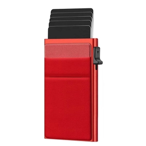 Macro view of red RFID blocking metal wallet showing the automatic card pop-up mechanism