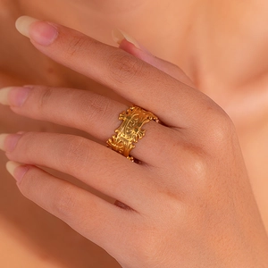 Macro view of a 18K gold hollow geometric ring featuring vintage hollowed patterns