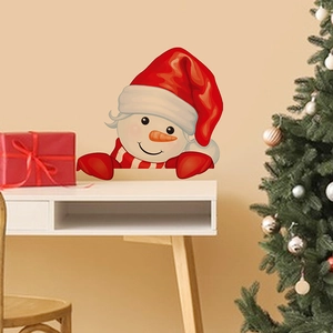 Close-up of a cute cartoon snowman wall sticker with a red hat in a cozy room
