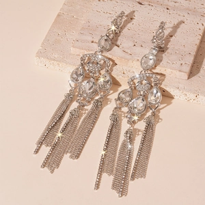 Macro shot of silver drop earrings with long rhinestone tassels and sparkling crystals