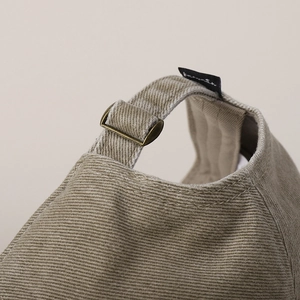 Detail of adjustable cotton strap and vintage bronze metal buckle on the baseball cap