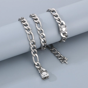 Polished titanium steel Figaro chain with a unique round clasp shown on a grey display stand